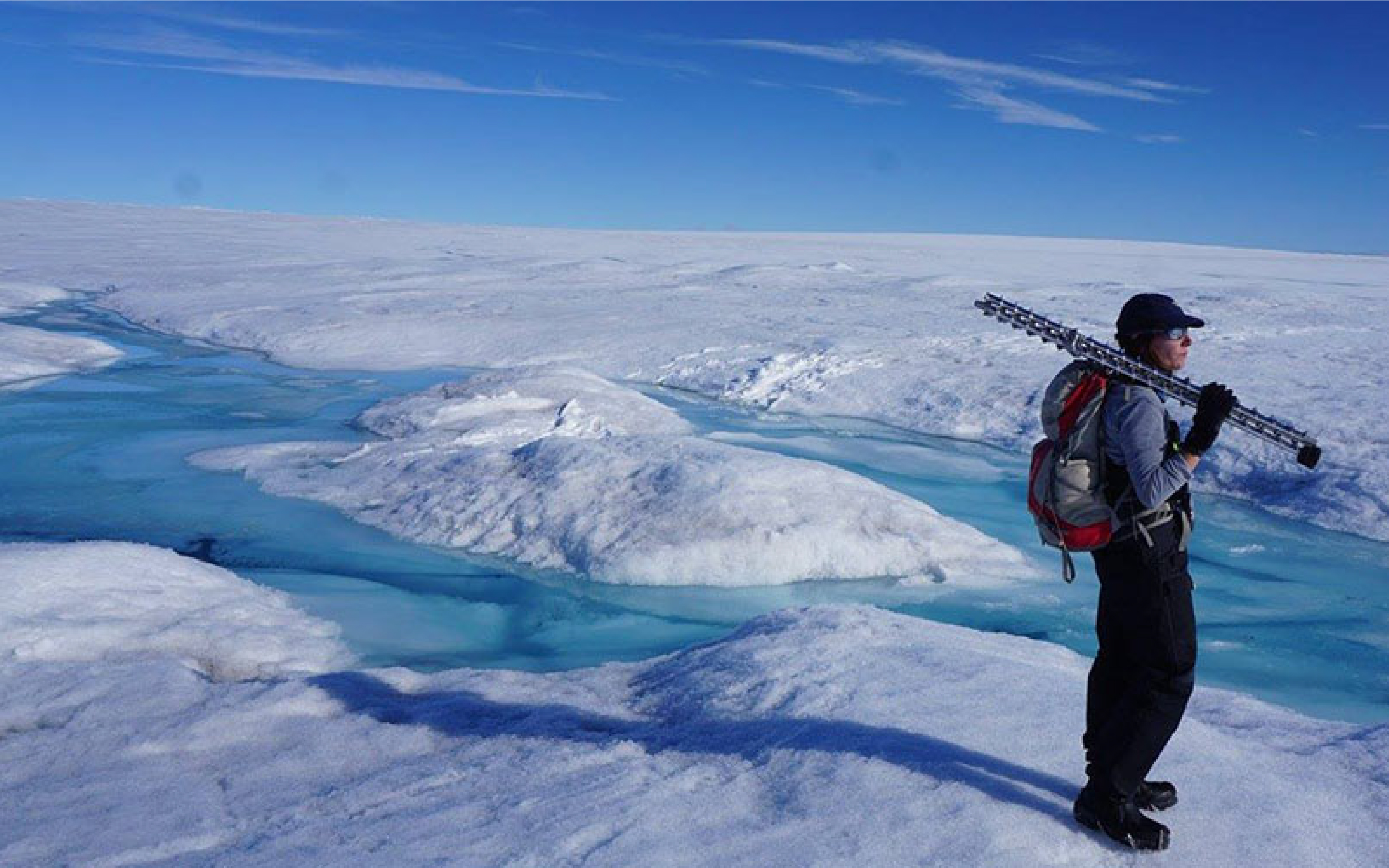 Graduate student Celia Trunz carries equipment used to monitor stream flow